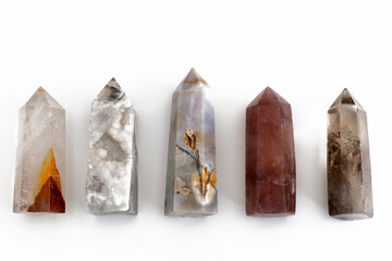 A top view image of several healing crystal towers in a row on a white background.