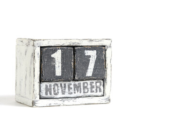 November 17 on wooden calendar, on white background.