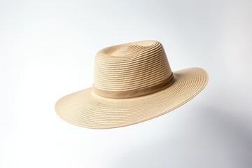 Fototapeta na wymiar White Boater Straw Hat Flying Isolated in Studio. Concept of Fashion Clothing Accessory and Beach