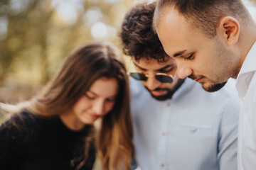 University students study subjects together in the park, exchanging knowledge, solving problems, and preparing for exams. It is a happy, successful day of learning and teamwork.