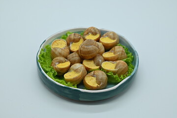 macro snails with white sauce photo above, snails with basil pesto, Grana Padano and pine nuts	