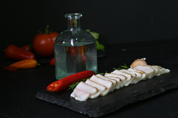 Ukrainian lard with vodka and red pepper, alcoholic feast concept 