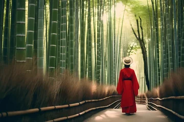 Foto auf Glas Asian woman in bamboo forest wearing traditional Japanese kimono at Bamboo Forest in Kyoto, Japan © Denisa