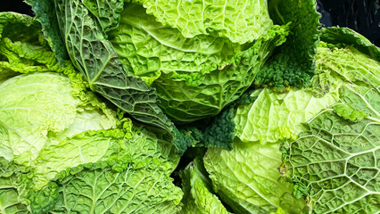 fresh savoy cabbage in the market, close-up, background