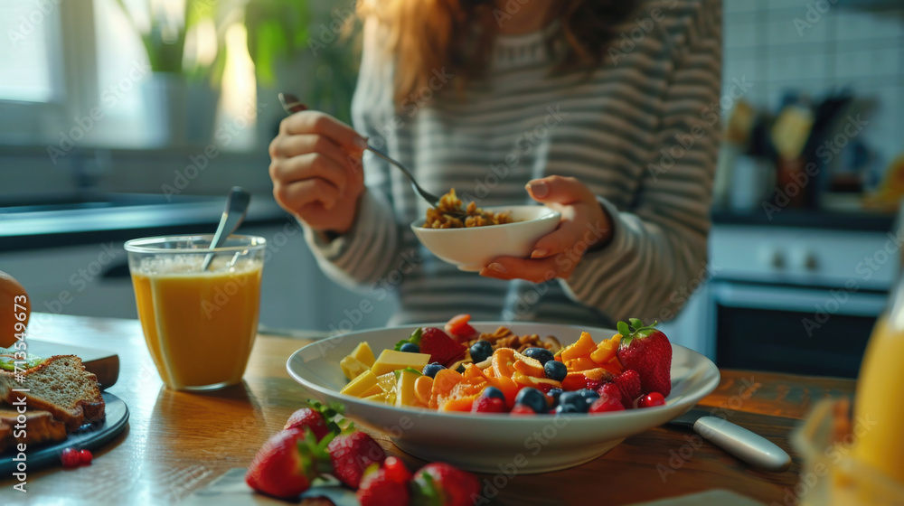 Poster a woman sitting at a table with a bowl of fruit. suitable for various uses