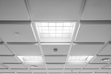 A room illuminated by numerous lights on the ceiling. Ideal for showcasing a well-lit and spacious interior.