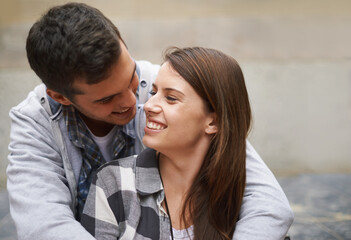 Obraz premium Eye contact, happiness and face of couple hug together, relax and enjoy outdoor date for Valentines Day anniversary. Trust, connection and people smile for relationship security, soulmate or devotion