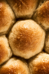 Burger Buns or mini buns in the round baking pan. Very soft Freshly Baked Homemade, buttered. White marble background. Minimalistic photo. Top view. Close Up