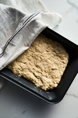 Focaccia bread dough in the baking pan. Uncooked and unbaked. 