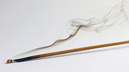 A picture of a lit cigarette with smoke emanating from it. This image can be used to illustrate smoking, addiction, or health-related topics