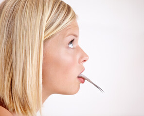 Profile of woman with fish in mouth in studio with shock, healthy food and omega 3 supplements....