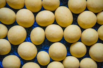 yellow chocolate dragee. Chocolate dragee on a blue background close up