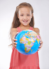 Kid, portrait and globe in studio with world, planets and city for education, geography and happy. Student, girl child and travel map with smile for earth day support or lesson on white background