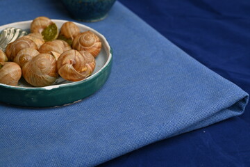 macro snails with pesto sauce photo above, snails with basil pesto, Grana Padano and pine nuts