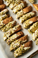 Golden Biscotti or Cantuccini on the baking pan. Traditional Sweet Italian cookies that are making with two times baking, with nuts and dried cranberries. Extra crunchy and dry