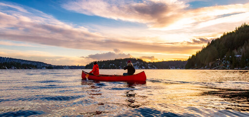 People on Wooden canoe paddling in water. Indian Arm, Deep Cove, North Vancouver
