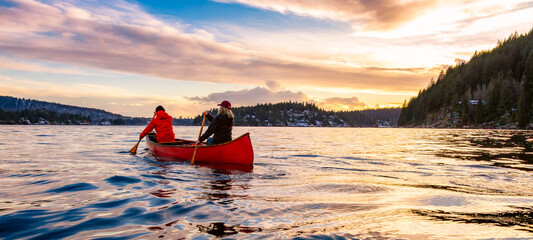 People on Wooden canoe paddling in water. Indian Arm, Deep Cove, North Vancouver