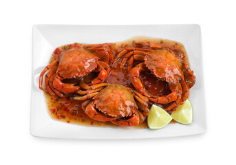 Delicious boiled crabs with sauce and lime isolated on white, top view