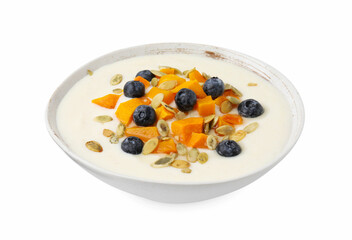 Bowl of delicious semolina pudding with blueberries, pumpkin and seeds isolated on white