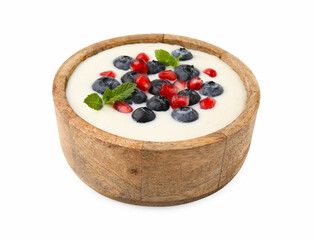 Bowl of delicious semolina pudding with blueberries, pomegranate and mint isolated on white