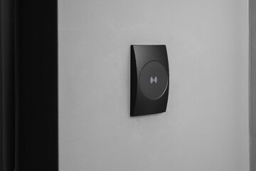 Magnetic door lock on grey wall. Home security