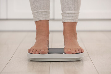 Menopause, weight gain. Woman standing on floor scales indoors, closeup - obrazy, fototapety, plakaty