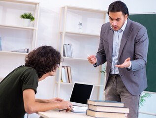 Young teacher and student in the classroom