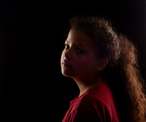 Photo of young girl, a beautiful low key photo of a beautiful girl from Brazil, selective focus.