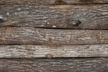 Background of raw boards with tree bark on one side