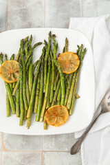 Top View of Grilled Asparagus with Lemon on a White Plate