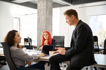 Handsome man in business suit talking to attractive woman