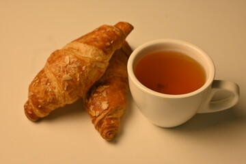 black tea and croissants, cup of tea and croissants, breakfast concept 