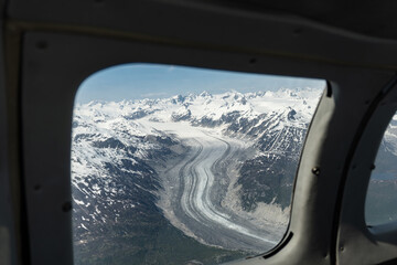 Glacier seen from small airplane in Lake Clark Pass, Alaska. Dark debris lines called lateral or...