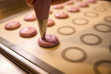 Professional baker is making cookies on kitchen countertop