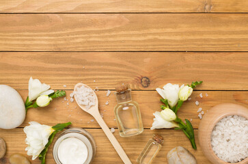 Fototapeta na wymiar Flat lay with spa products and flowers on wooden background