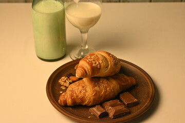  cup of tea and croissants, breakfast concept, bottle of milk and a glass of milk and croissants,
