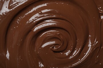 Tasty milk chocolate paste as background, top view