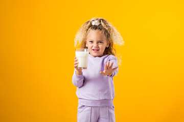 Young Girl Expressing Dislike with a Glass of Milk . Illustrating Lactose Intolerance and the...
