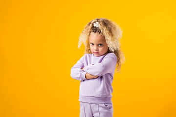 Offended child girl with crossing arms on her chest. Negative human emotions, reactions and...