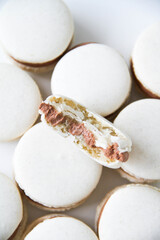 French dessert macaron with milk chocolate ganache on a white background
