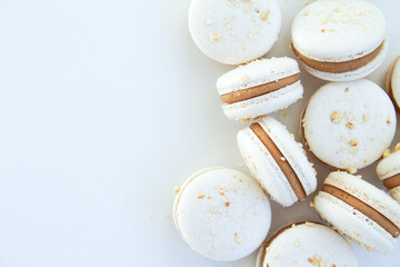 French dessert macaron with milk chocolate ganache on a white background