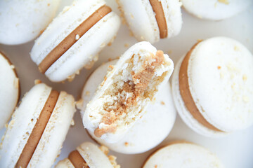 French dessert macaron with milk chocolate ganache on a white background