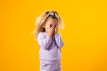 Crying girl with hands covering her eyes. Negative emotion, depression, stress concept.