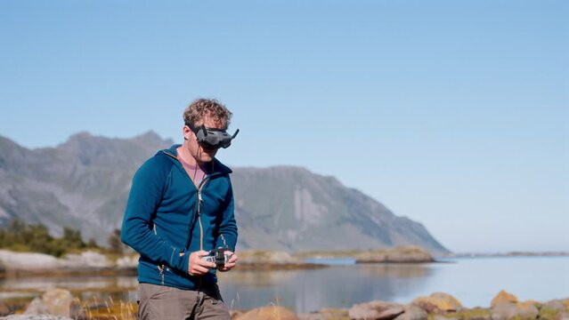 Man In FPV Goggles Directs Drone From The Ground