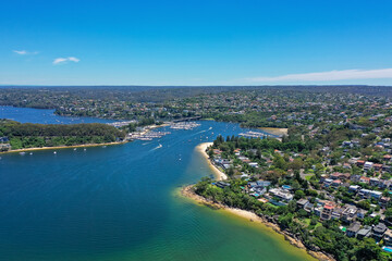 High angle aerial drone view of Spit Bridge, Clontarf Beach and Sandy Bay in the suburb of Clontarf, Sydney, New South Wales, Australia. Northern Beaches area of Sydney in the background.