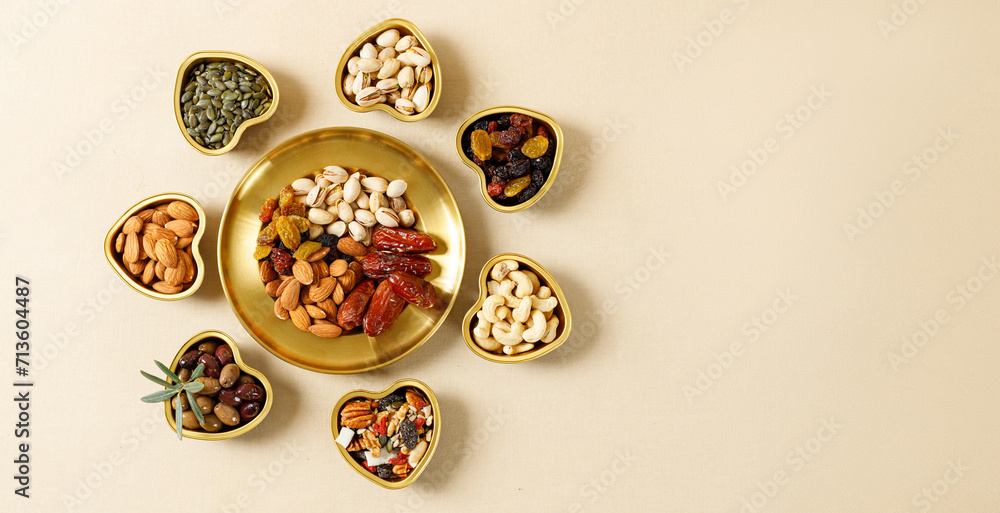 Wall mural mixed nuts and dried fruits on a gold plates. symbols of the jewish holiday of tu bishvat. healthy s - Wall murals