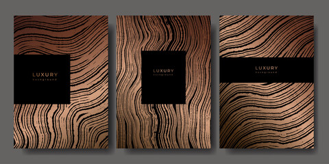 Set of templates. Luxury golden background with wood annual rings texture. Banner with tree ring pattern. Stamp of tree trunk in section. Wooden concentric circles. Black and bronze marble background © Morena