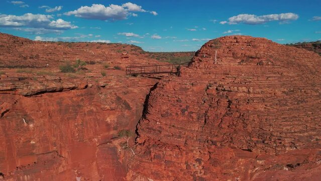 An aerial rising view of  walk bridge at King Canyon, Australia in the late afternoon..