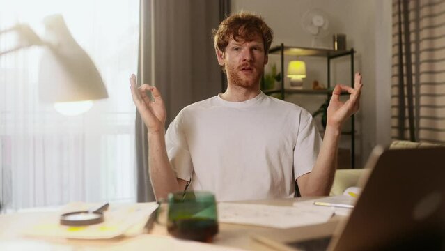 Nervous freelancer with closing eyes trying to meditate practice yoga after hard work day when someone calls intrusively and distracts at home Angry man screaming at someone who disturb him indoors