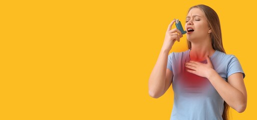Young woman with inhaler having problems with lungs on yellow background with space for text